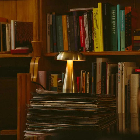 A cordless Portable Metal Touch lamp glowing warm on a table