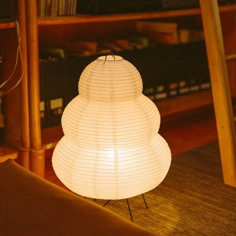 Warm rice paper floor lamp lighting a Collingwood living room